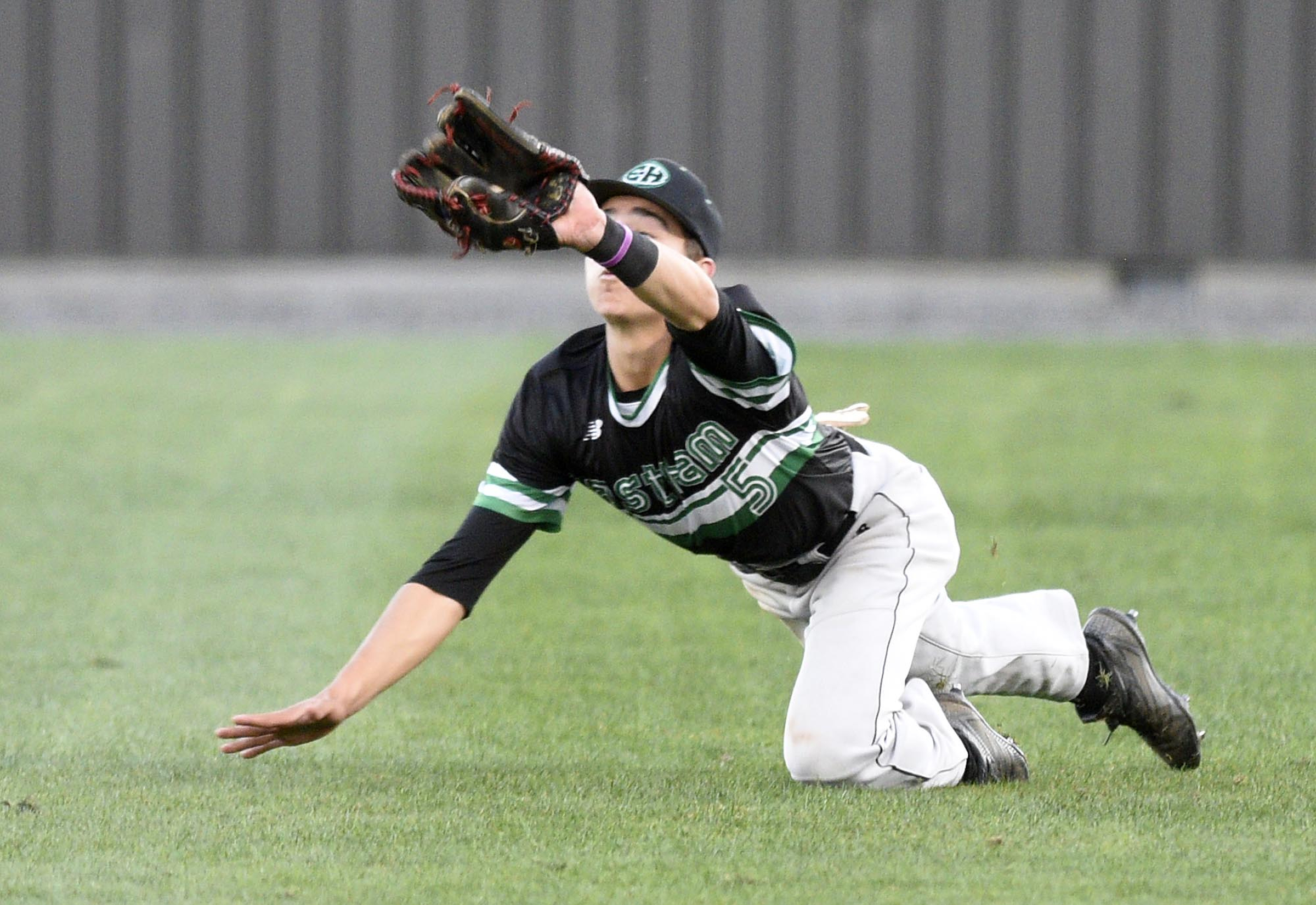 East Hamilton right fielder Jack Stone makes a diving catch. The East Hamilton Hurricanes visited the Bradley Central Bears in TSSAA baseball action on April 16, 2019.