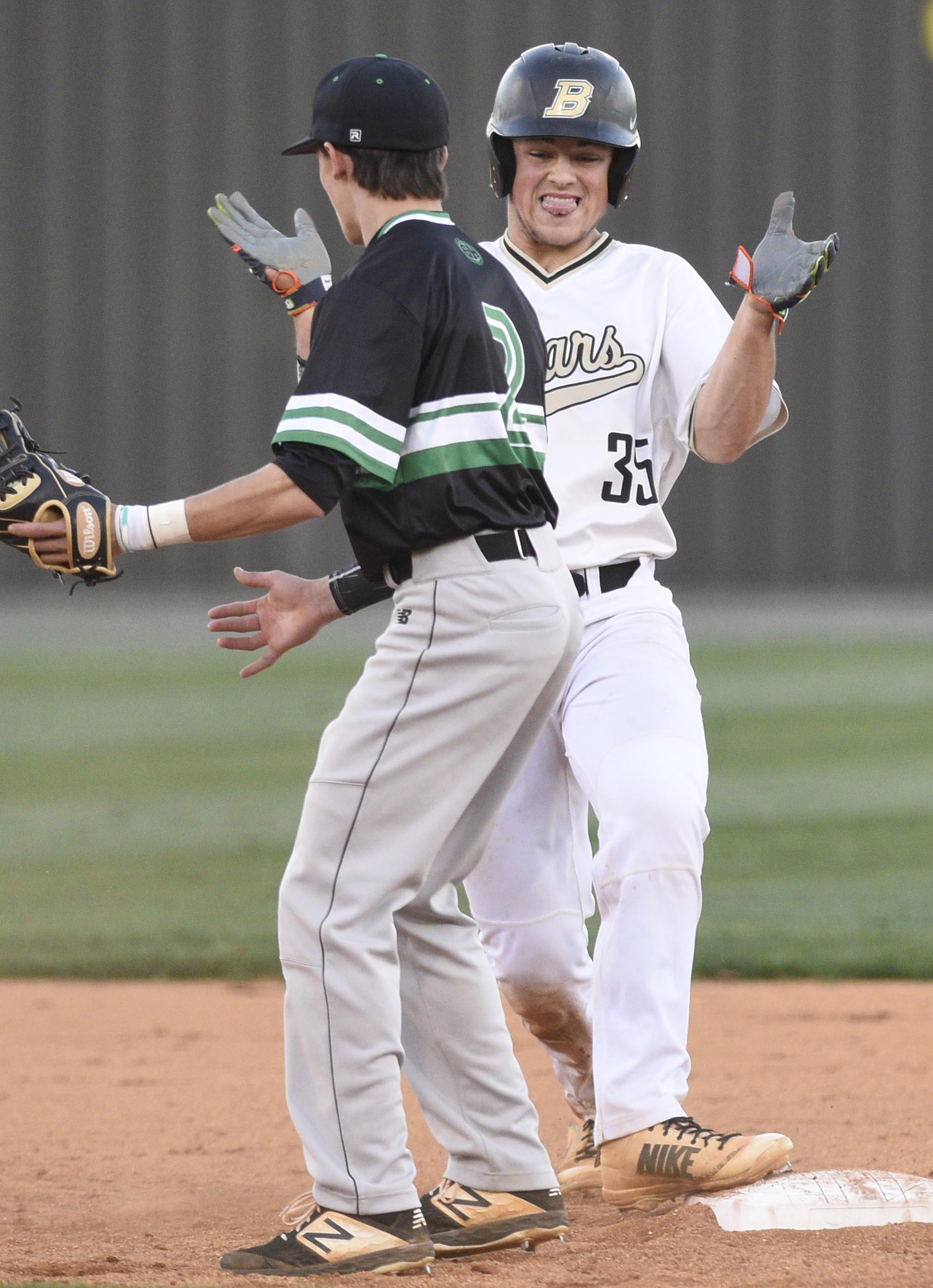 Bradley Central's Riley Black (35) celebrates his two-run double on the base next to East Hamilton's Conner Thornburg. Bradley's Bears beat the visiting Hurricanes 4-1 in District 5-AAA baseball.