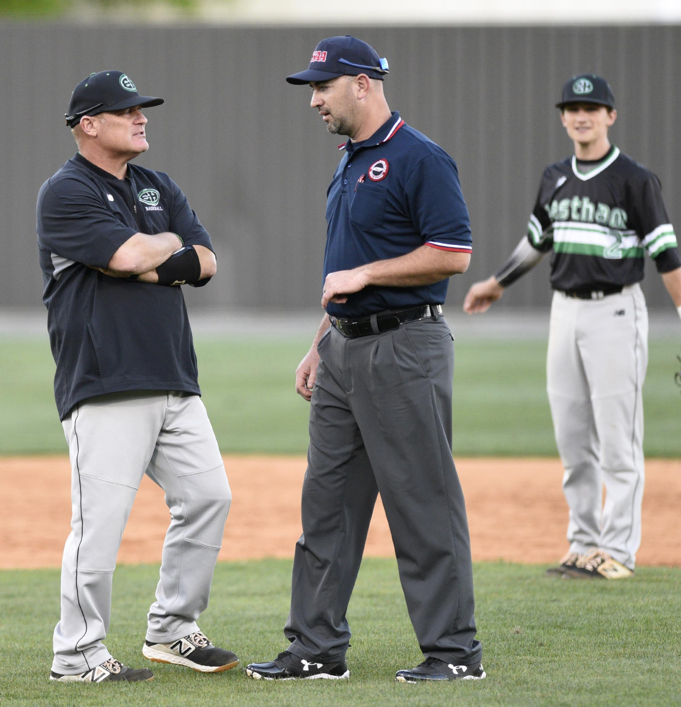 East Hamilton head coach Steve Garland discusses a close call with the umpire, at right is Hurricane second baseman Conner Thornburg (2). The East Hamilton Hurricanes visited the Bradley Central Bears in TSSAA baseball action on April 16, 2019.