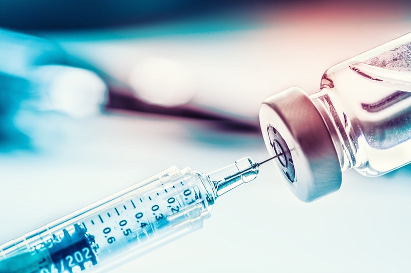 Close-up medical syringe with a vaccine. vaccine tile / Getty Images