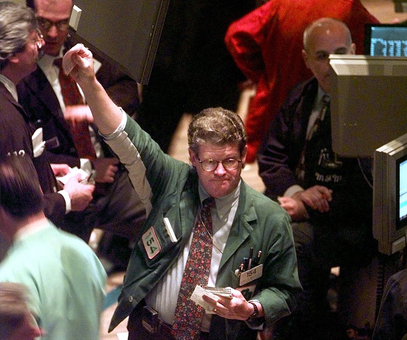 FILE - In this June 23, 1998, file photo traders work on the floor of the New York Stock Exchange. The furious rally for stocks this year, so quickly on the heels of last year’s scary tumble, is reminding some investors of the market’s rebound in late 1998. (AP Photo/Adam Nadel, File)