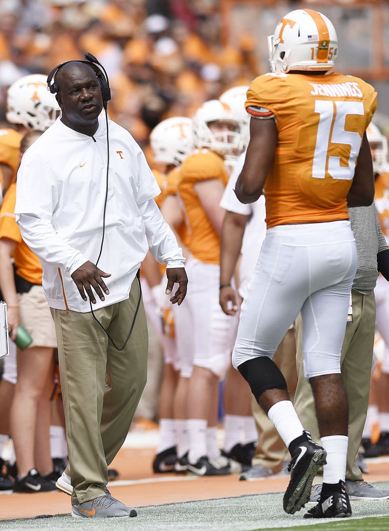 Tennessee assistant coach David Johnson speaks to Jauan Jennings during a home game against UTEP last September. Johnson has switched from working with receivers to running backs since last season, with former Vols quarterback Tee Martin now coaching receivers.