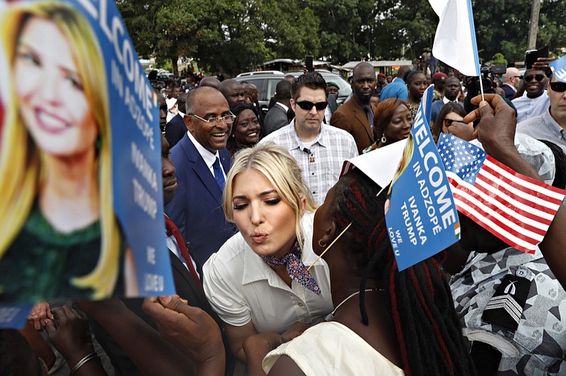 White House senior adviser Ivanka Trump is greeted by kisses as she is welcomed by local people holding U.S. flags and small flags that say "Welcome In Adzope Ivanka Trump We Love U," in Adzope, Ivory Coast, Wednesday April 17, 2019, where she will visit Cayat, a cocoa and coffee cooperative. Trump is in Ivory Coast to promote a White House global economic program for women. (AP Photo/Jacquelyn Martin)

