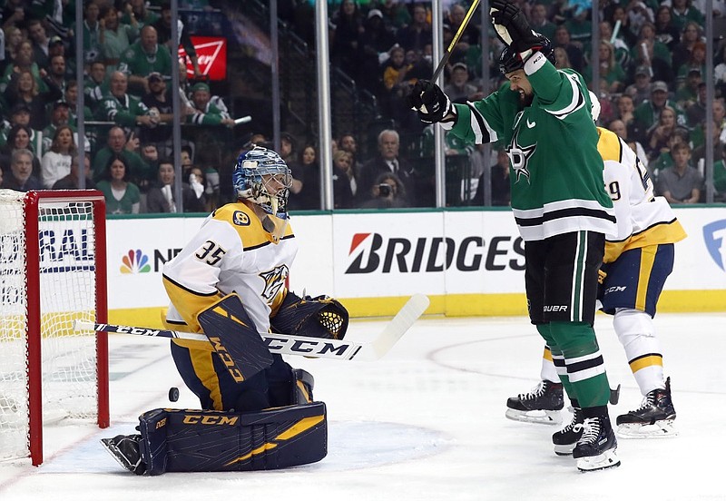 Nashville Predators goaltender Pekka Rinne (35) watches as Dallas Stars left wing Jamie Benn (14) celebrates a goal scored by teammate Roope Hintz during the first period of Game 4 of their Western Conference first-round playoff series Wednesday night in Dallas.