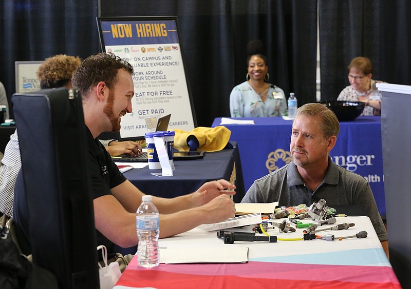 Josh Ball, a human resources senior specialist at DENSO, speaks with Larry Luttrell during a job fair put on by EPIC Talent Solutions Wednesday, August 22, 2018 at the Chattanooga Times Free Press in Chattanooga, Tennessee. DENSO was at the event to hire a variety of employees including, but not limited to individuals with production, engineering or accounting backgrounds.
