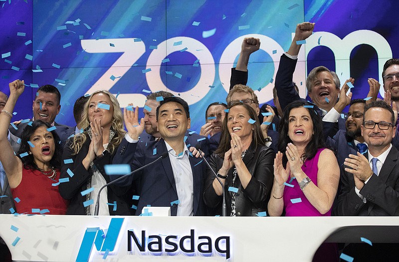 Zoom CEO Eric Yuan, center, celebrates the opening bell at Nasdaq as his company holds its IPO, Thursday, April 18, 2019, in New York. The videoconferencing company is headquartered in San Jose, Calif. (AP Photo/Mark Lennihan)