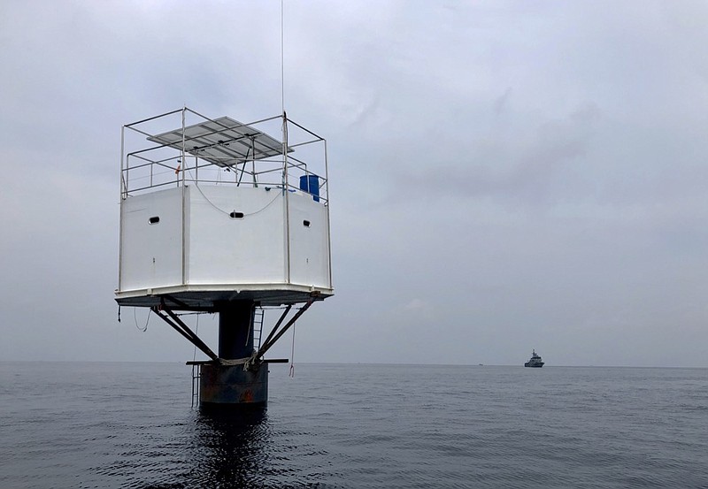 This Saturday, April 13, 2019, photo provided by Royal Thai Navy, shows a floating home lived in by an American man and his Thai partner in the Andaman Sea, off Phuket island, Thailand. Thai authorities raided Thursday, April 18, 2019, the floating home lived in by the couple who sought to be pioneers in the seasteading movement, which promotes living in international waters to be free of any nation's laws. Thailand's navy claims they endangered national sovereignty, an offense punishable by life imprisonment or death. (Royal Thai Navy via AP)

