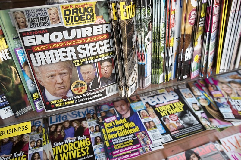 FILE - In this July 12, 2017 file photo, an issue of the National Enquirer featuring President Donald Trump on its cover is displayed on a newsstand in a store in New York. The tabloid's owner, American Media announced Thursday, April 18, 2019, that it is selling the supermarket weekly to James Cohen, the former head of the airport newsstand company Hudson News. (AP Photo/Mary Altaffer, File)

