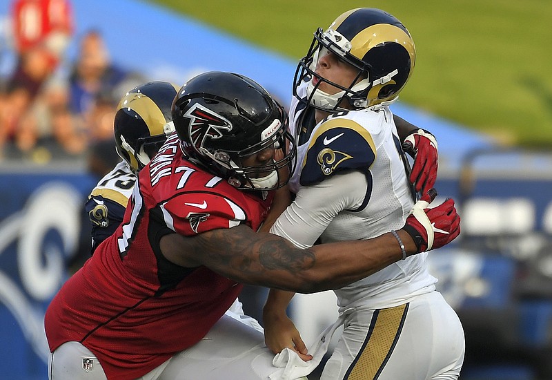 Atlanta Falcons defensive tackle Ra'Shede Hageman tackles Los Angeles Rams quarterback Jared Goff during a game in December 2016. Hageman did not play the past two seasons after being charged with domestic violence, but the Falcons signed him Friday.