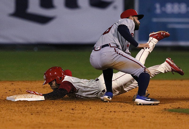 The Chattanooga Lookouts' Cassidy Brown safely slides into second base as Mississippi Braves shortstop Alejandro Salazar prepares to tag him during Friday night's game at AT&T Field. The Lookouts won 8-4 to end a five-game losing streak and avoid being swept by the Braves.