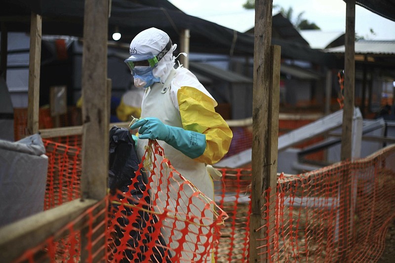 An Ebola health worker is seen at a treatment centre in Beni, Eastern Congo, Tuesday April,16, 2019. Congo's president on Tuesday said he wants to see a deadly Ebola virus outbreak contained in less than three months even as some health experts say it could take twice as long. (AP Photo/Al-hadji Kudra Maliro)

