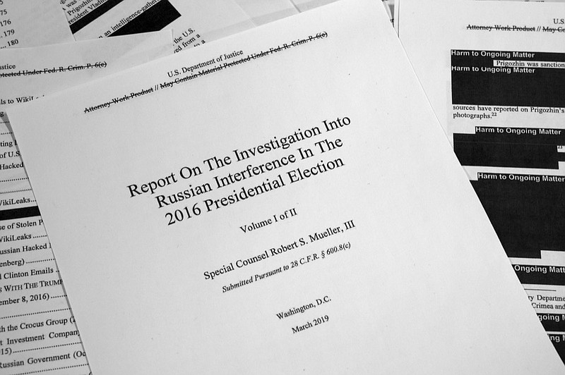 Special counsel Robert Mueller's redacted report on Russian interference in the 2016 presidential election as released on Thursday, April 18, 2019, is photographed in Washington. (AP Photo/Jon Elswick)

