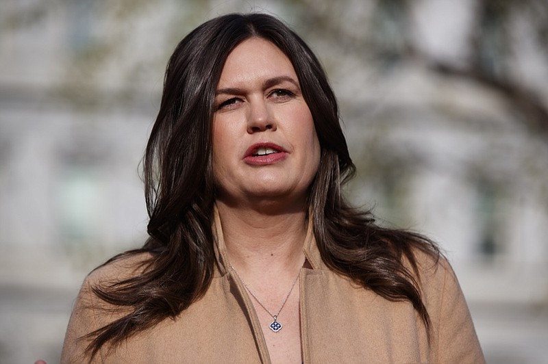 FILE - In this April 4, 2019, file photo, White House press secretary Sarah Sanders talks with reporters outside the White House in Washington. (AP Photo/Evan Vucci, File)

