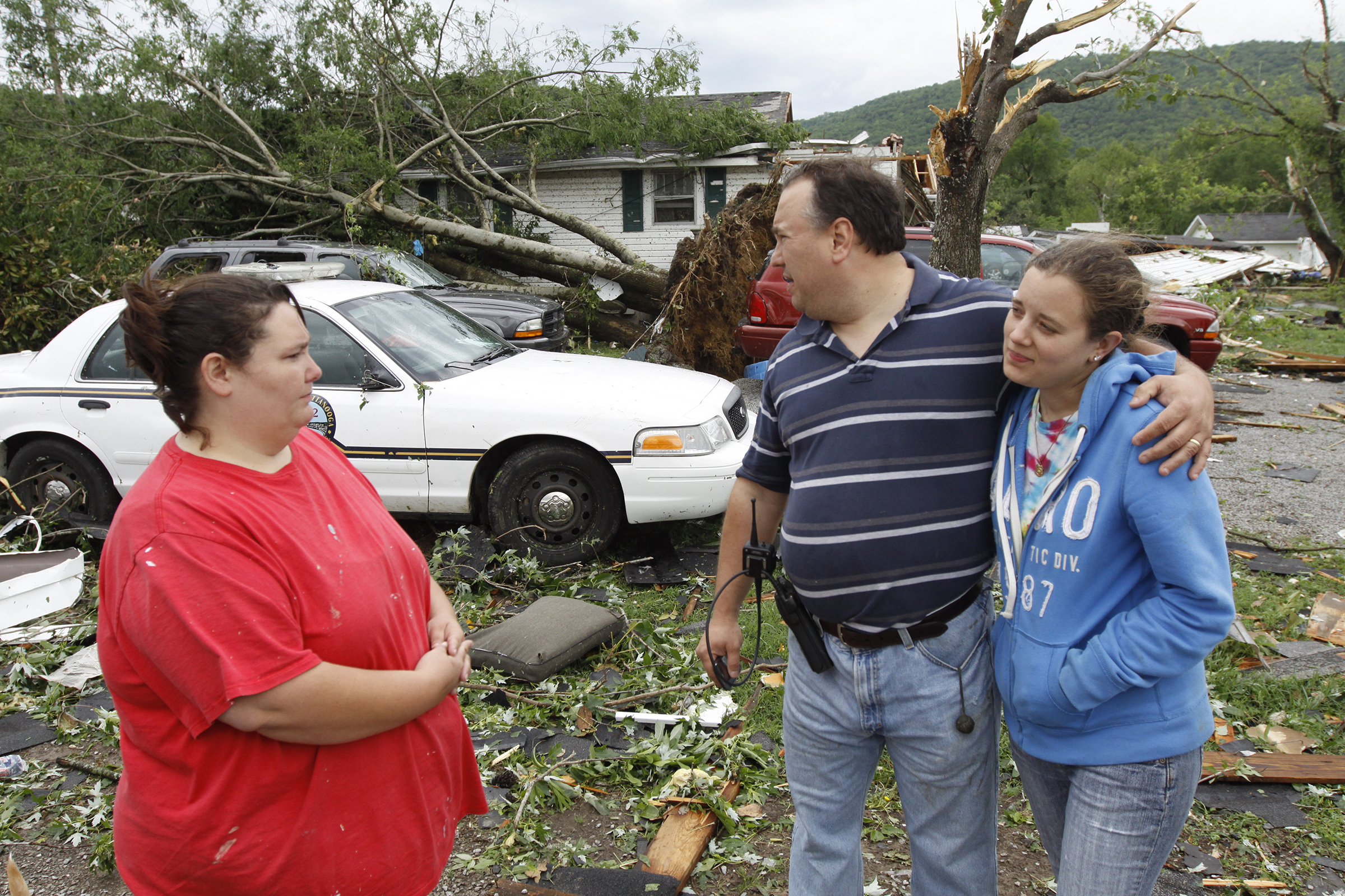 Staff photo by Dan Henry/Chattanooga Times Free Press - April 27, 2011. Valerie Culver, left, consoles Chattanooga Police Officer Eric Milchak and his wife Angela Milchak after a severe storm and strong winds damaged their Lookout Valley residence Wednesday morning.