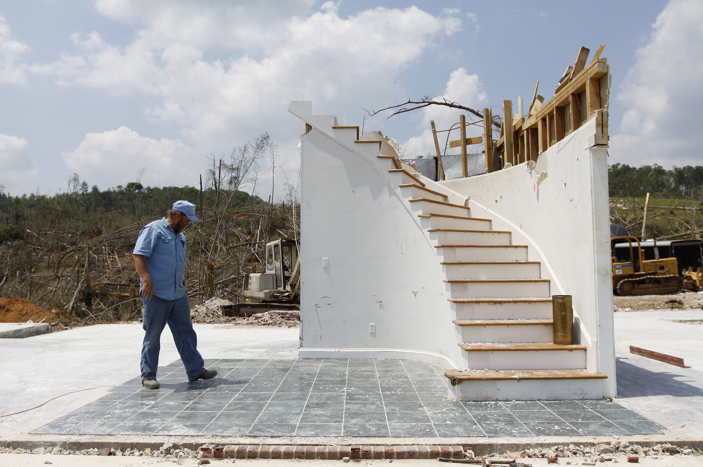 Staff photo by Dan Henry/Chattanooga Times Free Press - 5/10/11. Calvin Parris examines the marble floor and staircase he built while walking through what use to be his 2-story 3200 sq-ft residence off of Cherokee Valley Rd., in Ringgold, Ga., before last month's F-4 tornado demolished it.