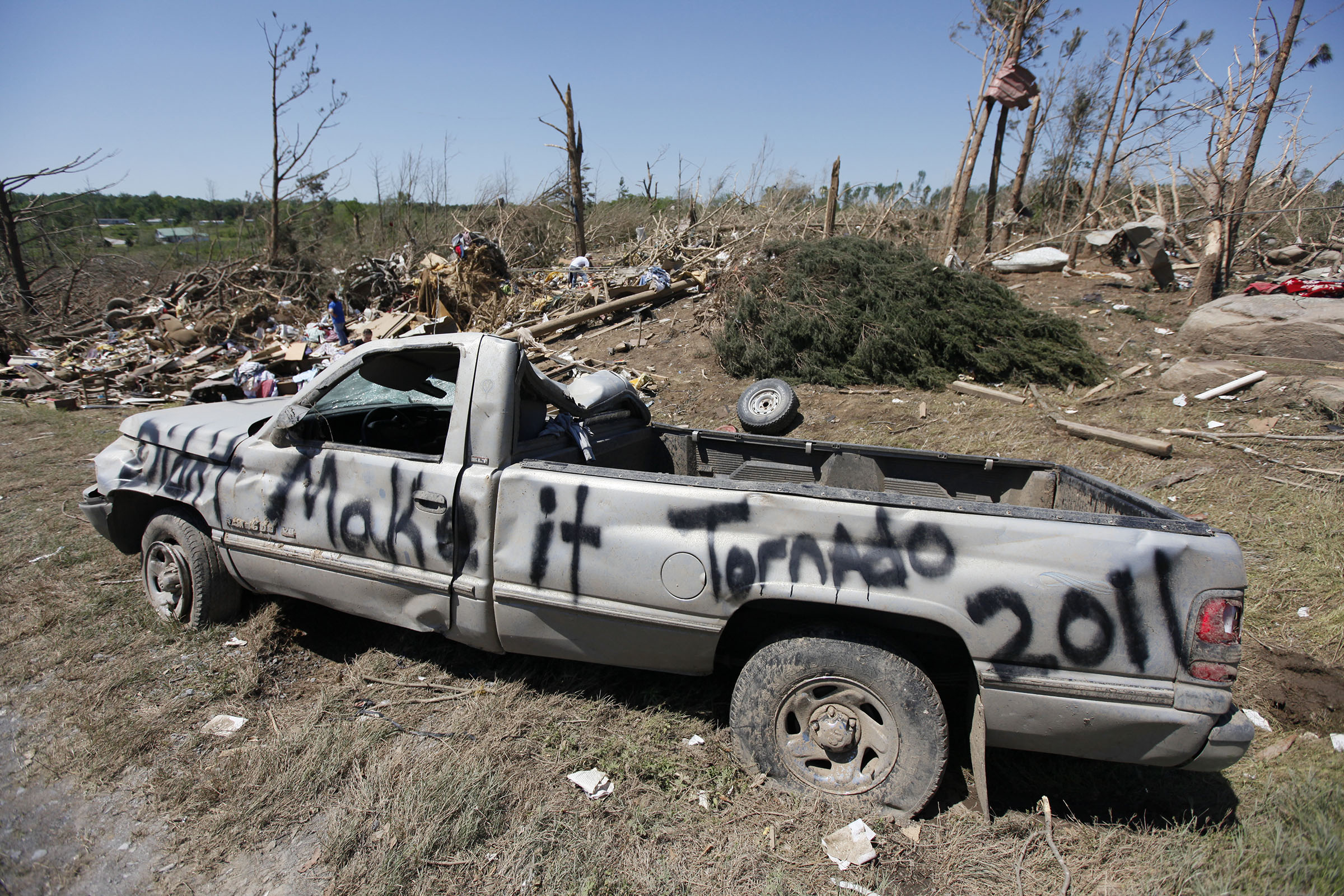 Staff Photo by Dan Henry/Chattanooga Times Free Press - March 29, 2011 - David Parris family had a sense of humor while painting his truck in front of what is left of his mobile home Friday morning in Rainsville, AL., as area residents clean up from a fatal tornado which took at least 32-lives in DeKalb County on Wednesday.
