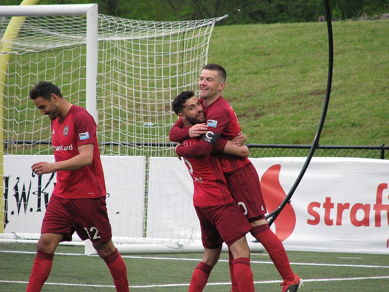 Chattanooga Red Wolves attacker Steven Beattie, far right, is embraced by Jonathan Caparelli after the first of his two goals Saturday. Eamon Zayed, left, also scored in Chattanooga's 3-2 victory over Tormenta FC at Chattanooga Christian School's David Stanton Field on Saturday night.