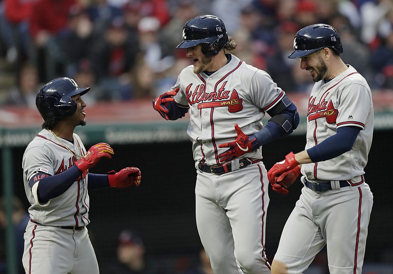 Atlanta Braves third baseman Josh Donaldson, center, is congratulated by Ozzie Albies, left, and Matt Joyce after he hit a three-run home run in the second inning of Sunday night's game against the Cleveland Indians.