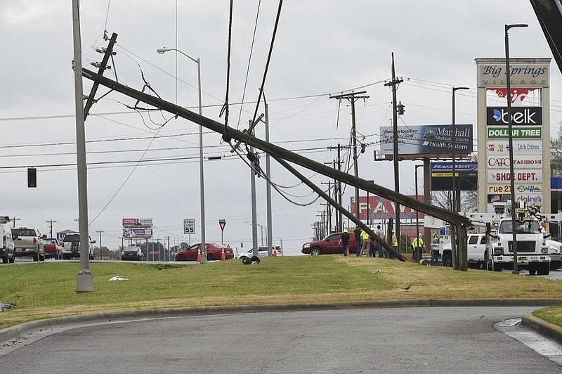 People stand at a damaged area in Guntersville, Ala., after a possible tornado Monday, April 8, 2019. The weather service said a tornado hit Blount County, and another one struck Guntersville. (Joe Songer/The Birmingham News via AP)