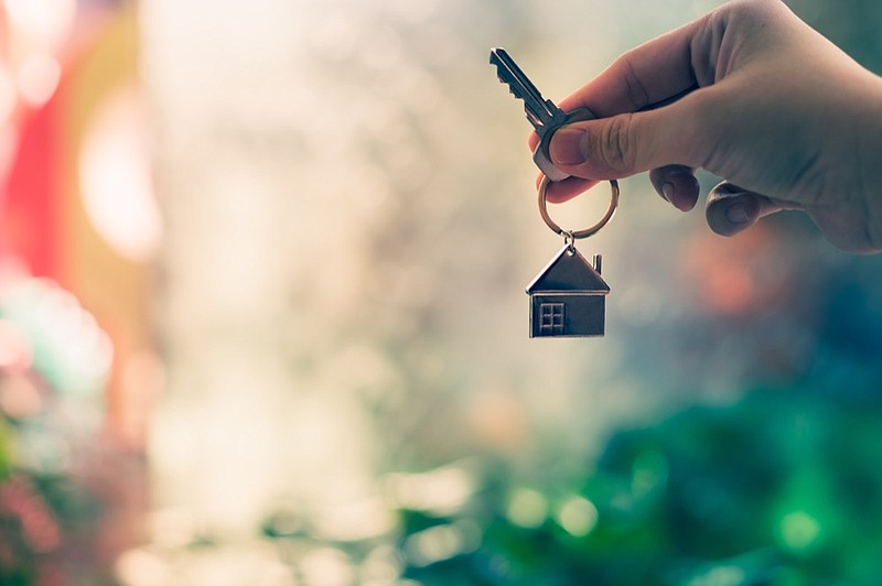 House model and key in home insurance broker agent hand or in salesman person. Real estate agent offer house, property insurance and security, affordable housing concepts / Getty Images