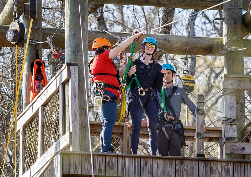 Reporter Sunny Montgomery gets clipped onto one of two ziplines at the High Point ZIP Adventure at Ruby Falls. (Staff photo by Doug Strickland)