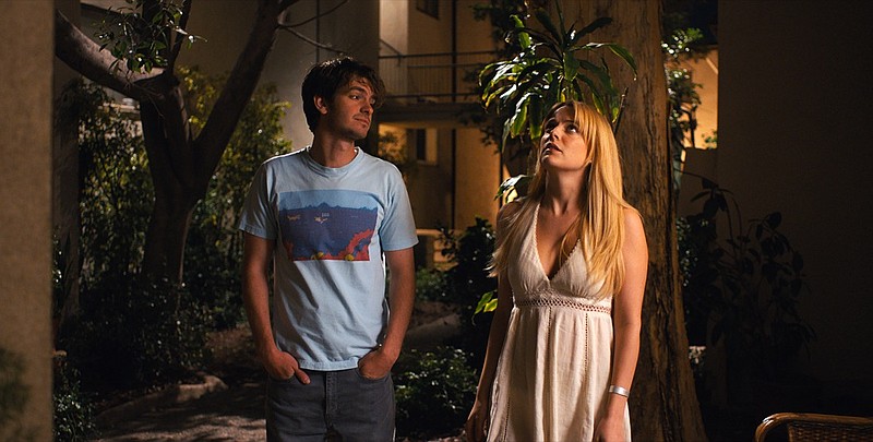 This image released by A24 shows Andrew Garfield, left, and Riley Keough in a scene from "Under the Silver Lake." (A24 via AP)