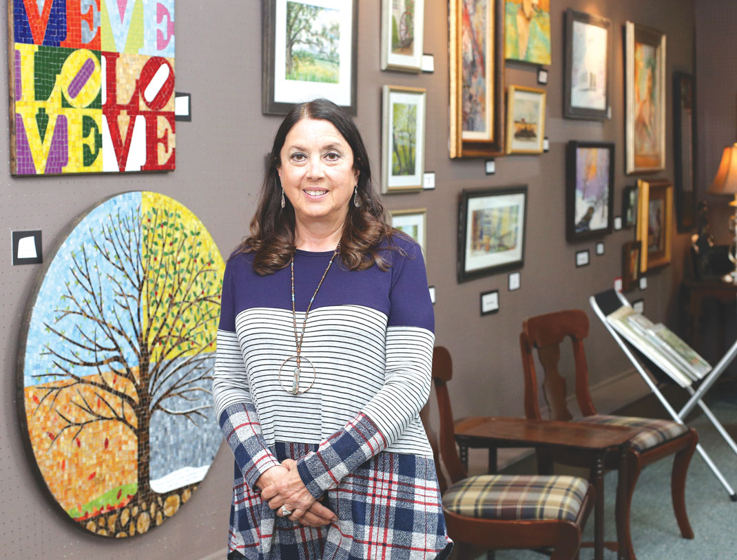 Raye Brooks, the owner of Ringgold Art and Frame Gallery, poses for a photo in her shop in Ringgold. / Photo: Erin O. Smith