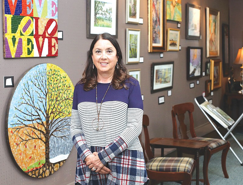 Raye Brooks, the owner of Ringgold Art and Frame Gallery, poses for a photo in her shop in Ringgold. / Photo: Erin O. Smith