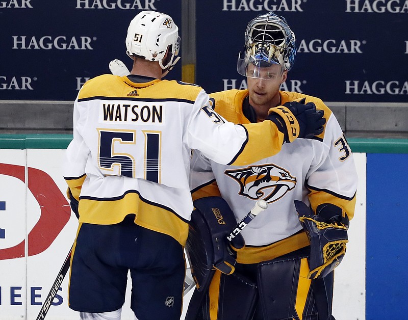 Nashville Predators forward Austin Watson taps goaltender Pekka Rinne on the shoulder after their 2-1 overtime loss to the host Dallas Stars on Monday night in Game 6 of their first-round playoff series. The Stars won the best-of-seven series 4-2.