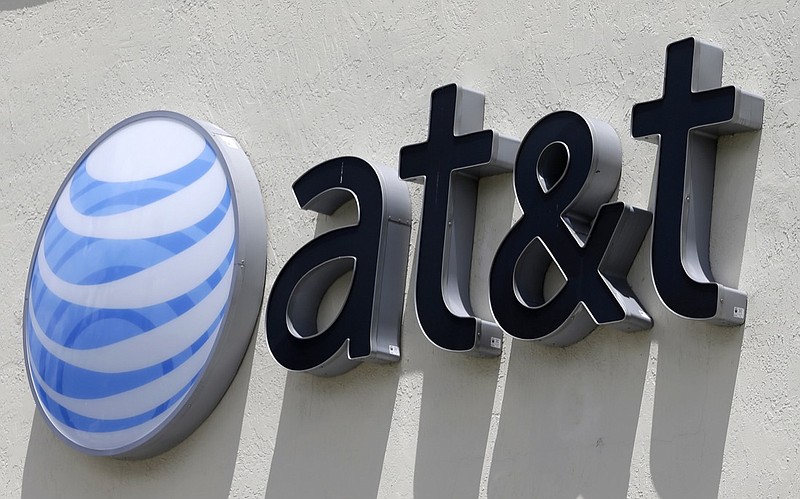 This July 27, 2017, file photo shows an AT&T logo at a store in Hialeah, Fla. AT&T reports earnings Wednesday, April 24, 2019. (AP Photo/Alan Diaz, File)