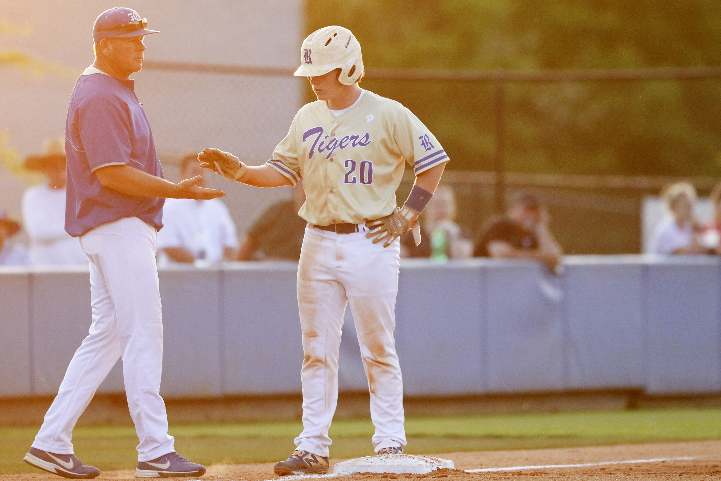 Ringgold head coach Brent Tucker celebrates with Daulton Schley (20) after he reached third base during the second game of a double header in the first round of the GHSA playoffs against Cherokee Bluff at Bill Womack Field at Ringgold High School on Wednesday, April 24, 2019 in Ringgold, Ga.
