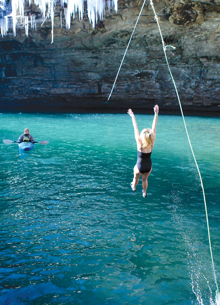 Lexis Robertson ziplines into the water during the second annual Lula Lake Polar Plunge.