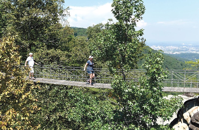 Mike and Gale Nickels, from Southgate, Mich., walk across the swing-along bridge at Rock City on Thursday, Sept. 3, 2015, in Lookout Mountain, Ga.