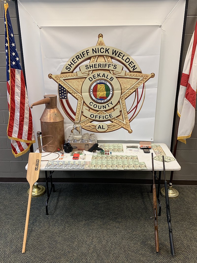 Officers with the DeKalb County (Alabama) Sheriff's Office, Drug Task Force and Fort Payne, Henegar and Ider police departments seized a dismantled moonshine still, methamphetamine, marijuana, cash, guns and steroids in searches conducted Tuesday night on Sand Mountain that landed seven people in jail.