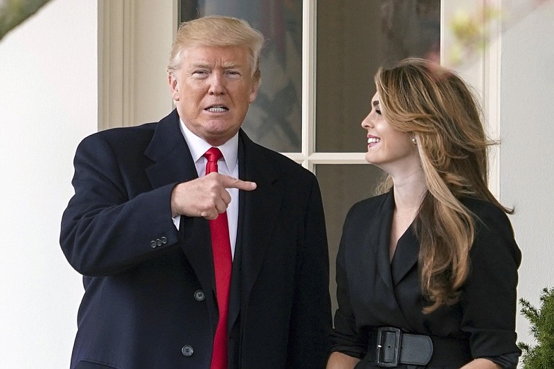 In this March 29, 2018, file photo, President Donald Trump points to outgoing White House Communications Director Hope Hicks on her last day before he boards Marine One on the South Lawn of the White House in Washington. The report of special counsel Robert Mueller shined a light on the much-discussed meeting of Donald Trump Jr., Jared Kushner and campaign officials with several people linked to Russia. When Kushner brought emails about that meeting to the White House, the president's communications director didn't sugarcoat her opinion: She told Donald Trump the emails were "really bad." (AP Photo/Andrew Harnik)