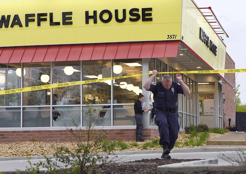 FILE- In this April 22, 2018 file photo, law enforcement officials work the scene of a fatal shooting at a Waffle House in the Antioch neighborhood of Nashville, Tenn. The father of the man accused of killing four people at the Waffle House in Tennessee last year pleaded not guilty Thursday, April 25, 2019, to charges related to the gun used in the shooting. Jeffrey Reinking is accused of giving an AR-15-style rifle to his 30-year-old son, Travis Reinking, who authorities said used it in Nashville on April 22, 2018. (George Walker IV/The Tennessean via AP, File)

