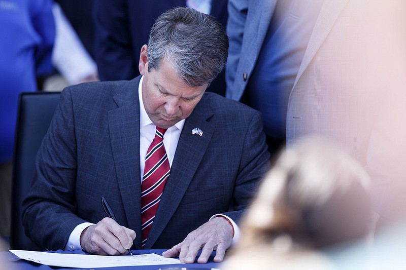 Gov. Brian Kemp sings a bill into law at Gordon Lee High School on Friday, April 26, 2019, in Chickamauga, Ga. / Staff photo by C.B. Schmelter