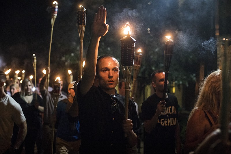 FILE — Members of the alt-right lead a torch march in Charlottesville, Va., Aug. 11, 2017. (Edu Bayer/The New York Times)