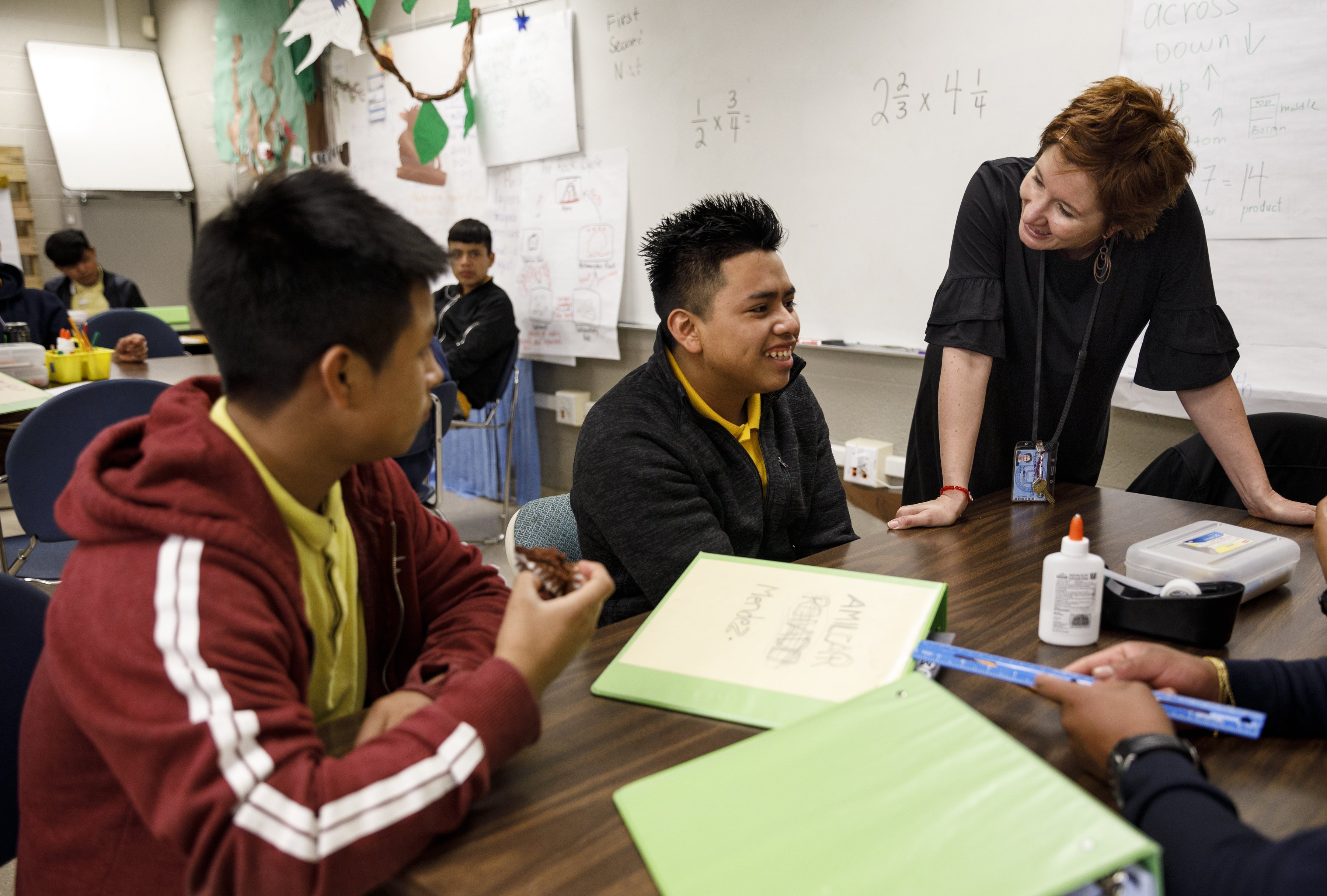 Teacher Emily Guyer, right, and student Deyner, left, talk with classmate Amilcar after singing him happy birthday at Howard School on Tuesday, April 23, 2019, in Chattanooga, Tenn. Howard has launched NewComer Academy to help acclimate new Hispanic students, who comprised nearly 60% of the school's 2019 freshmen class.