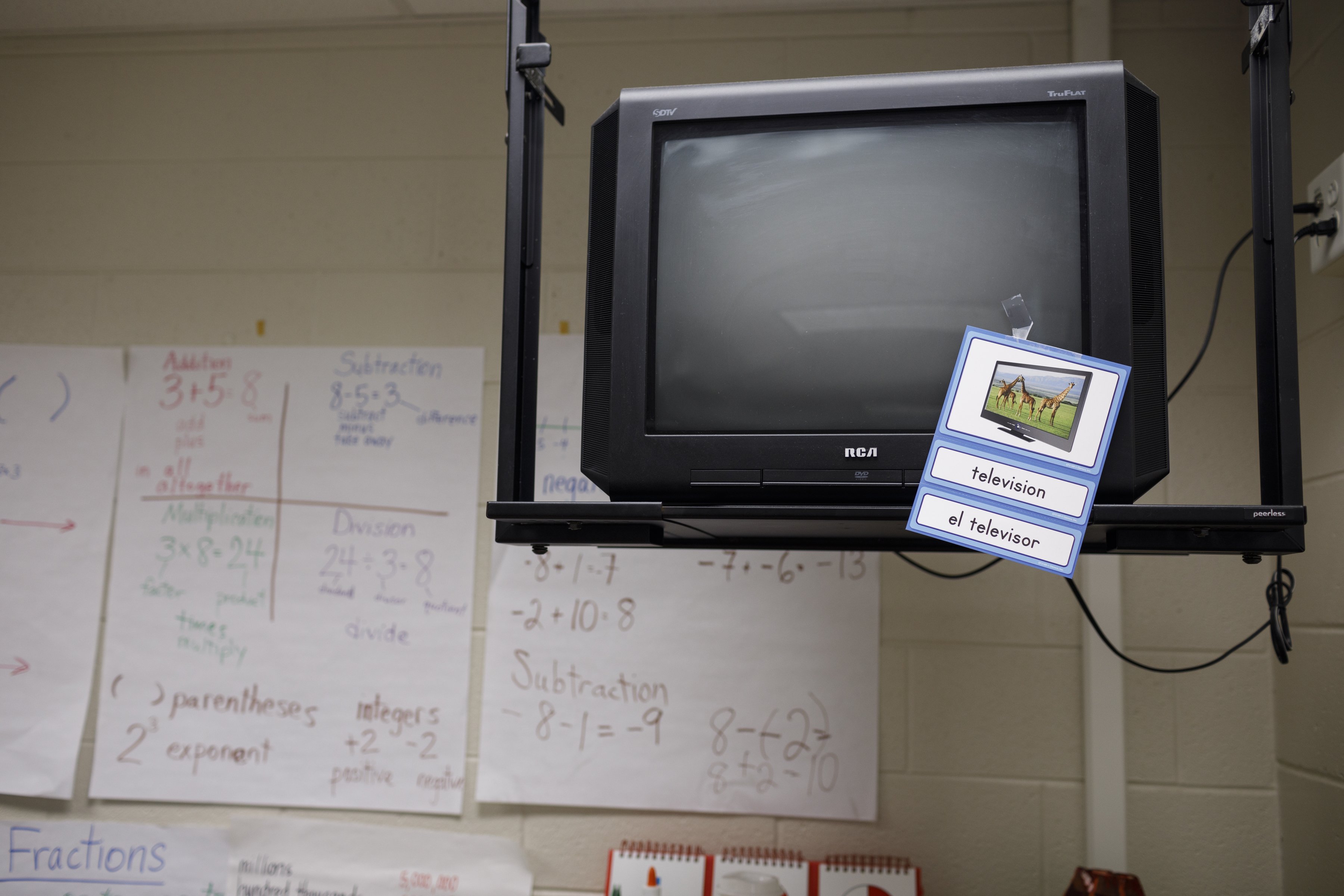 A tag with an English and Spanish translation hangs on a television in a NewComer Academy classroom at Howard School on Tuesday, April 23, 2019, in Chattanooga, Tenn. Howard has launched NewComer Academy to help acclimate new Hispanic students, who comprised nearly 60% of the school's 2019 freshmen class.