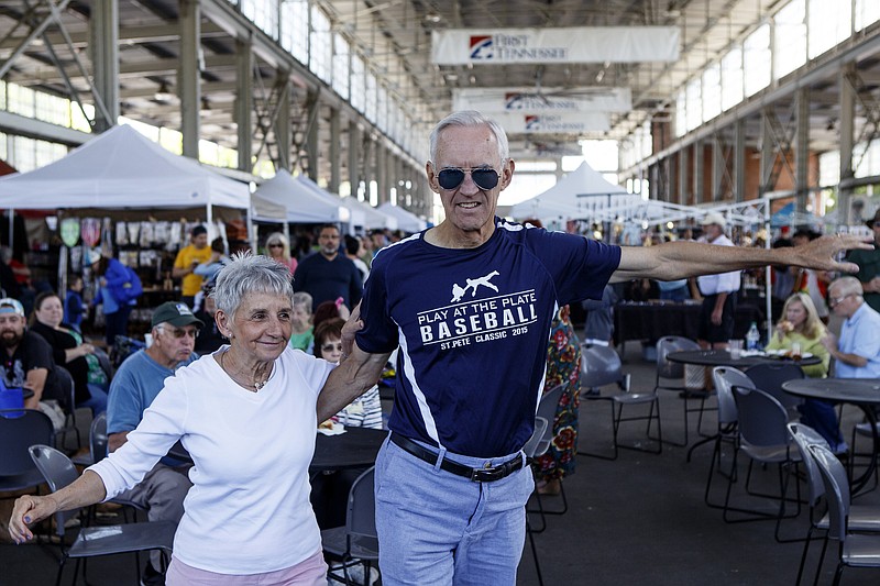 Linda Lewis, left, and Donald O'Connor dance as Sweet Georgia Sound plays during the opening weekend of the Chattanooga Market at the First Tennessee Pavilion on Saturday, April 27, 2019 in Chattanooga, Tenn.