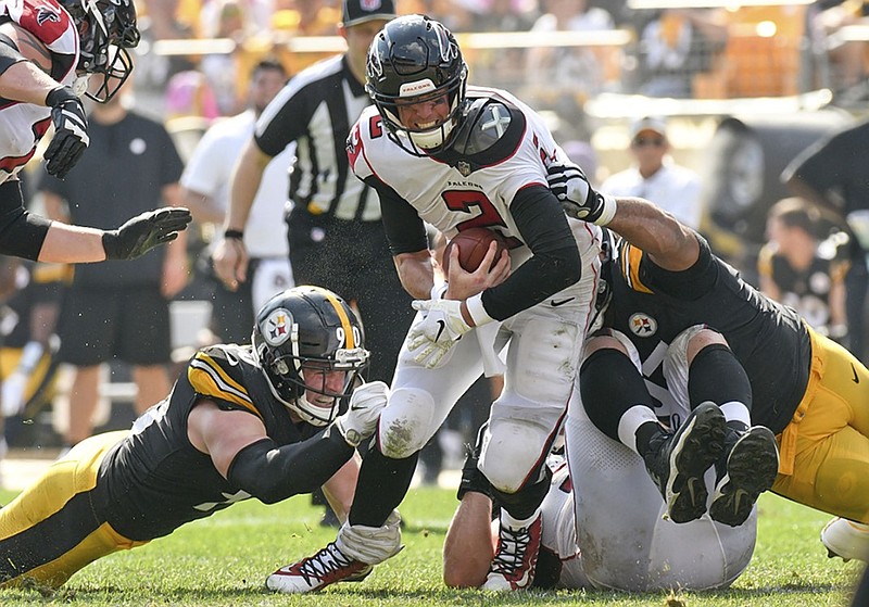 Atlanta Falcons quarterback Matt Ryan is sacked by Pittsburgh Steelers linebacker T.J. Watt, left, and defensive tackle Cameron Heyward during a game last October in Pittsburgh.