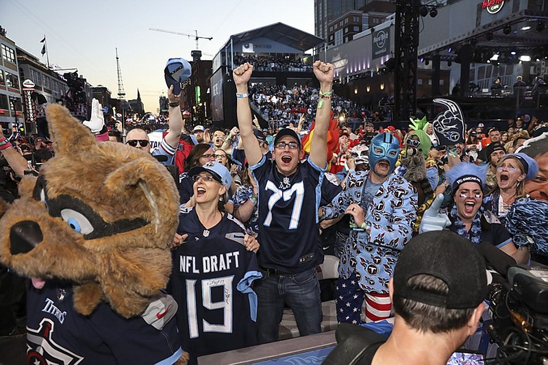 Tennessee Titans fans cheer during the NFL draft in downtown Nashville on Friday night after the team selected former Ole Miss receiver A.J. Brown in the second round.