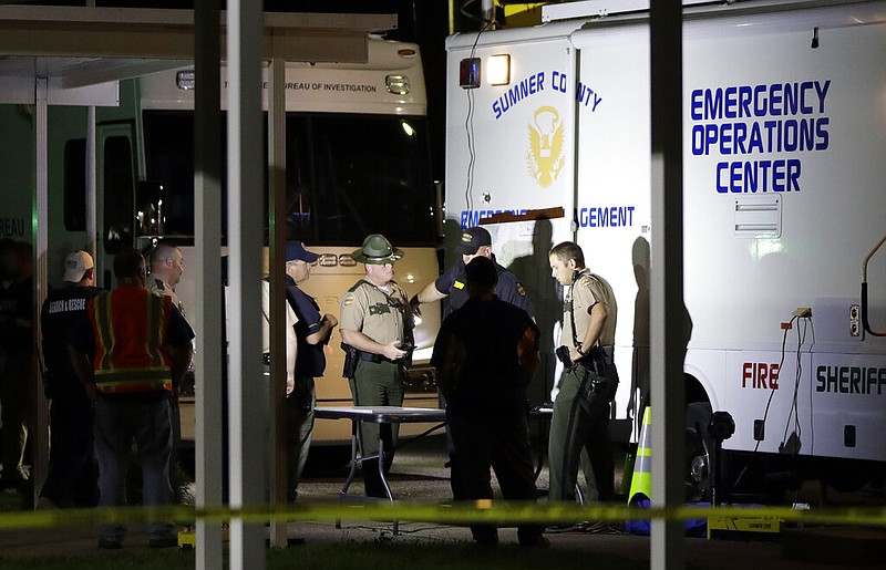 Law enforcement officials work at a command center set up at North Sumner Elementary School Saturday, April 27, 2019, in Bethpage, Tenn. Authorities in rural Tennessee captured a suspect Saturday during a manhunt that was prompted by the discovery of several bodies in two homes. (AP Photo/Mark Humphrey)