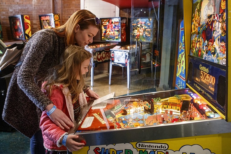 Lauren Tewalt plays the Super Mario Bros. Mushroom World pinball machine with her 6-year-old daughter Starla at the Classic Arcade Pinball Museum on Sunday, March 31, 2019, in Chattanooga, Tennessee. (Staff photo by C.B. Schmelter)
