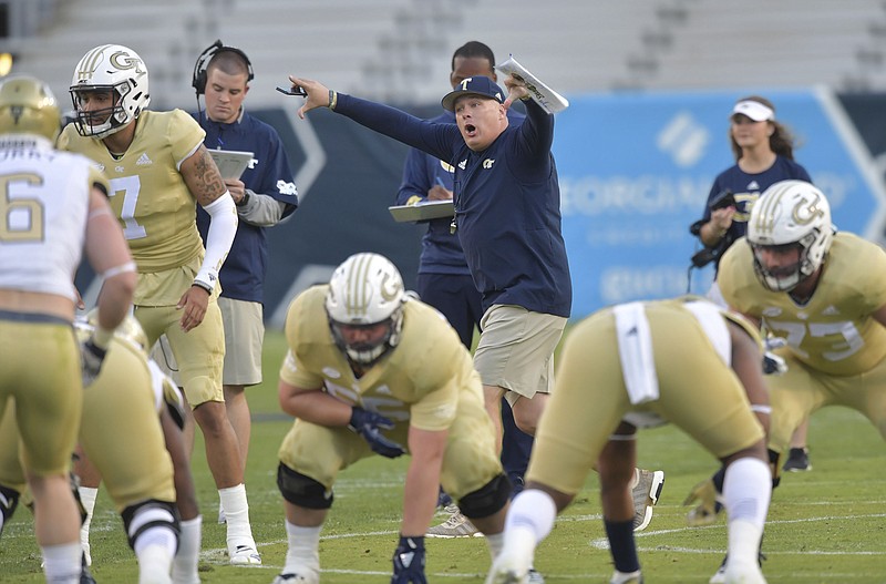 Georgia Tech football coach Geoff Collins, center, shouts instructions during the team's spring game Friday night in Atlanta. Collins, formerly at Temple, is preparing for his first season with the Yellow Jackets and spent this spring trying to help them learn a new offense.