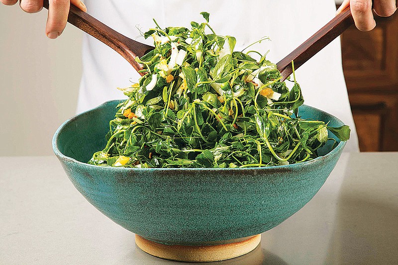 This undated photo provided by America's Test Kitchen in April 2019 shows a Pea Green Salad with Warm Apricot-Pistachio Vinaigrette in Brookline, Mass. This recipe appears in the cookbook "Vegetables Illustrated." (Daniel J. van Ackere/America's Test Kitchen via AP)