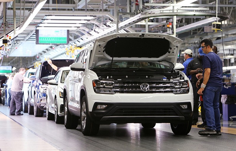 Volkswagen employees work around vehicles moving down the assembly line at the Volkswagen Assembly Plant Thursday, Aug. 31, 2017, in Chattanooga, Tenn.