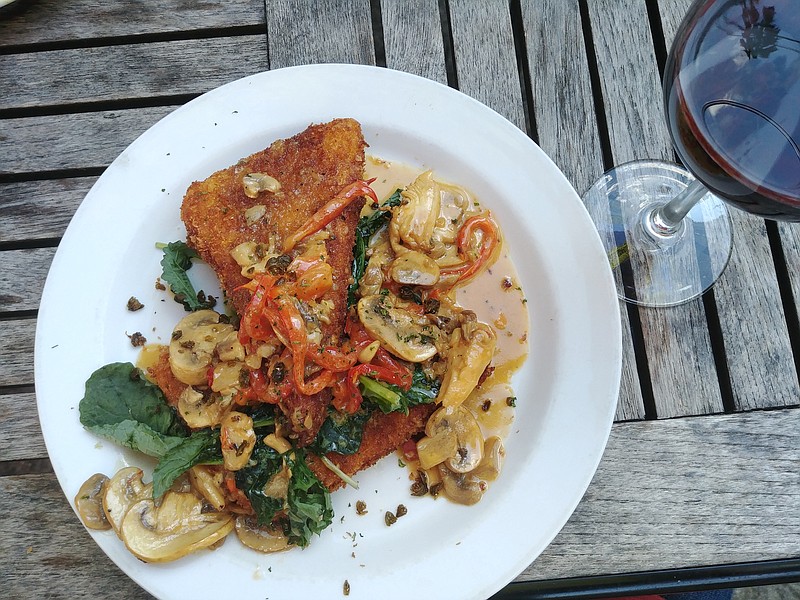 Grits cake served with wild mushrooms, wilted baby kale, lemon butter pan sauce, roasted red peppers, fried capers and fresh herbs.