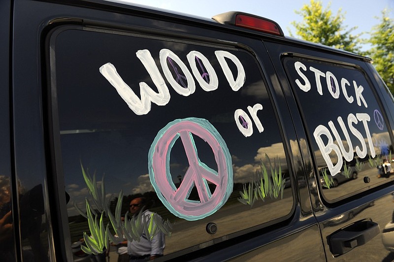 FILE - This Aug. 14, 2009 file photo shows a van decorated with "Woodstock or Bust" at the original Woodstock Festival site in Bethel, N.Y. Woodstock 50 is proving to be as chaotic as the original festival held in 1969. A financial investor in the festival announced Monday, April 29, 2019, it was pulling its funding from the anniversary event, set to take place Aug. 16-18 in Watkins Glen, N.Y. (AP Photo/Stephen Chernin, File)

